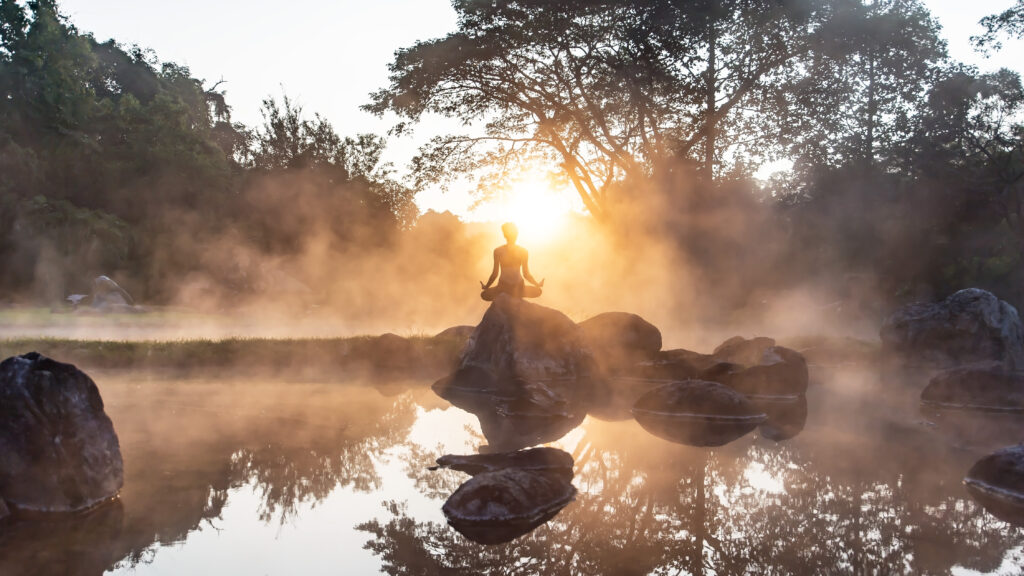 Young woman in silhouette practice yoga in a hot spring